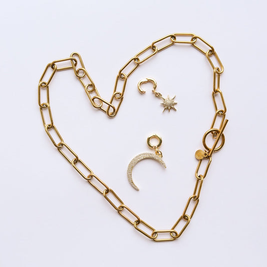 Gold chain necklace and charms with locks on a white background
